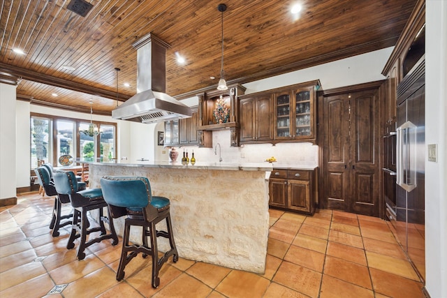 kitchen with island exhaust hood, tasteful backsplash, wood ceiling, sink, and hanging light fixtures