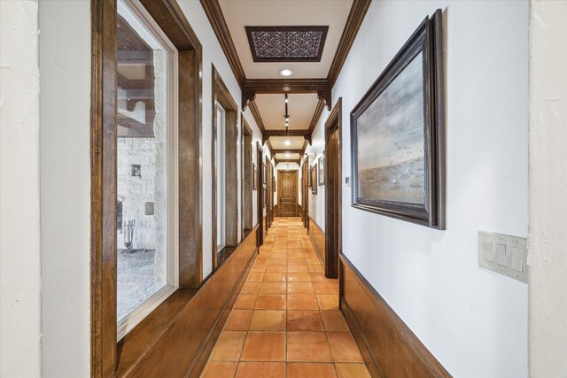 hall featuring ornamental molding and light tile patterned floors