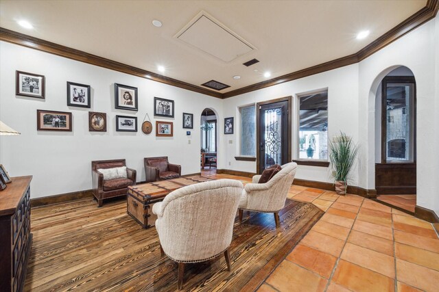 living room with crown molding and light tile patterned flooring