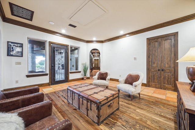 living room with tile patterned floors and ornamental molding