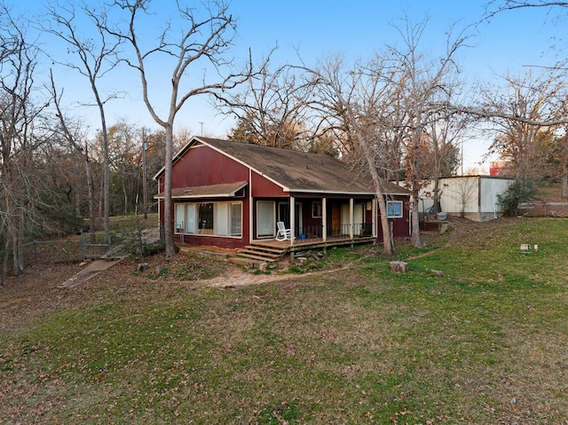 rear view of property featuring a yard