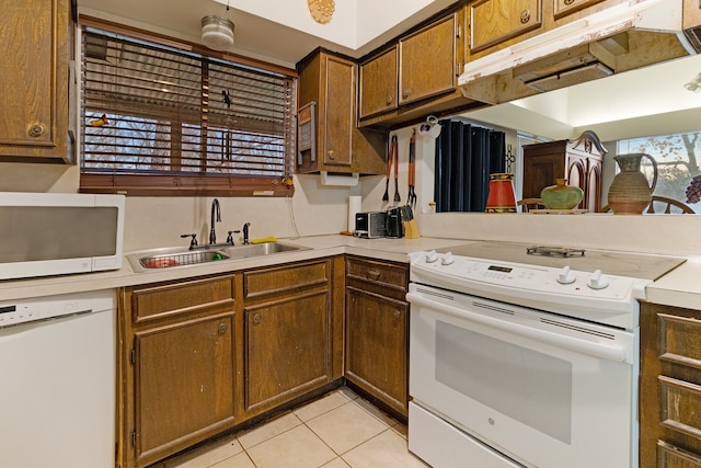 kitchen featuring custom range hood, white appliances, sink, and light tile floors