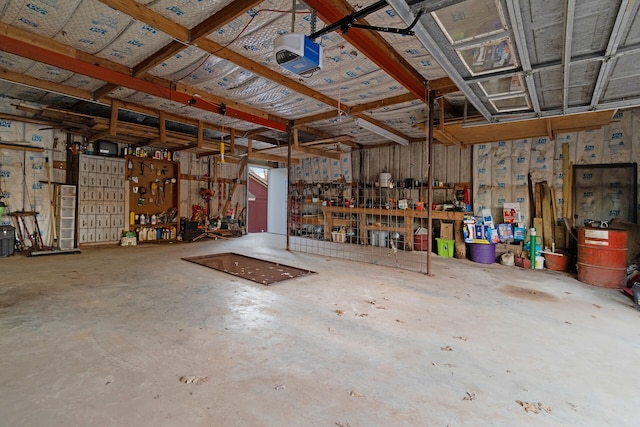 garage with a workshop area and a garage door opener