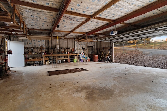 garage featuring a garage door opener and a workshop area