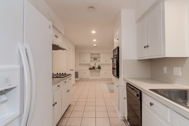 kitchen featuring light tile patterned flooring, sink, white cabinetry, and black appliances