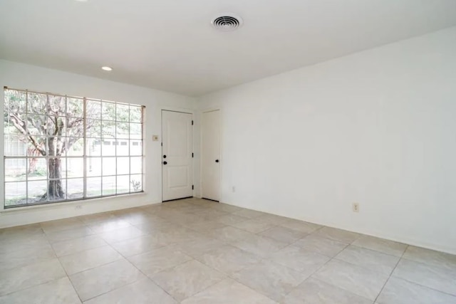 empty room with light tile patterned floors