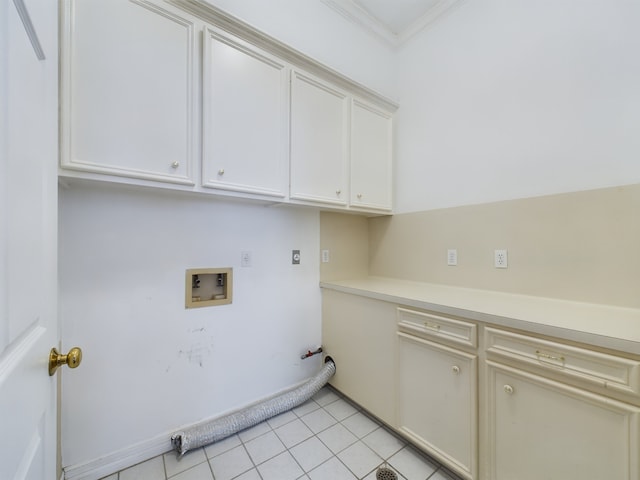 washroom featuring electric dryer hookup, cabinets, crown molding, hookup for a washing machine, and light tile patterned floors