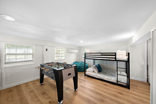 interior space featuring a wall mounted air conditioner and light hardwood / wood-style floors