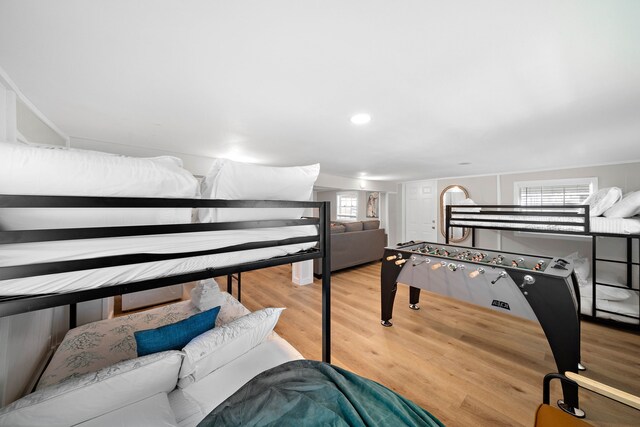 bedroom with hardwood / wood-style flooring and multiple windows