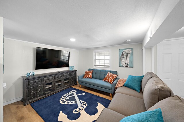 living room with hardwood / wood-style floors and ornamental molding