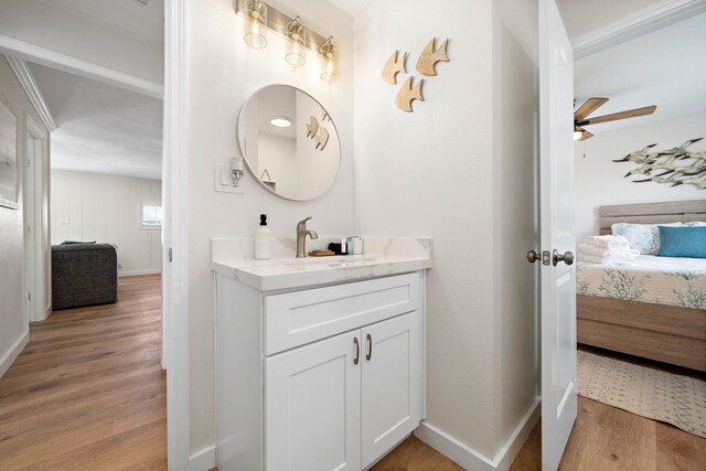 bathroom with vanity, hardwood / wood-style floors, and ceiling fan