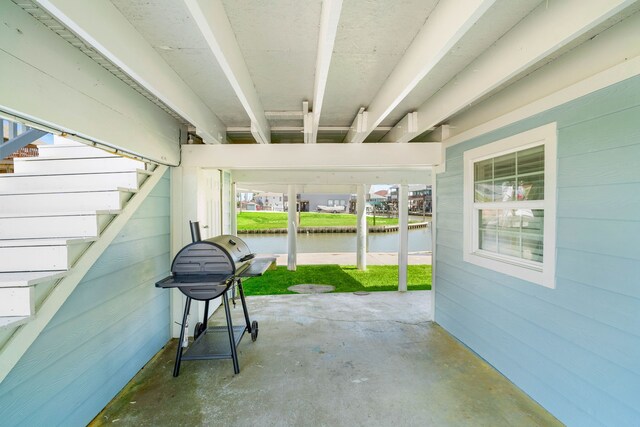 view of patio featuring a water view and area for grilling