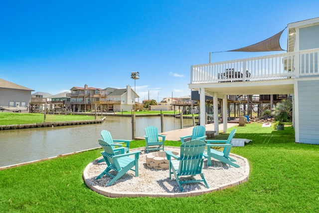 exterior space with a water view and a fire pit