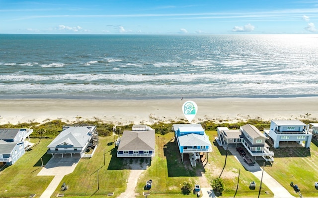 drone / aerial view featuring a water view and a beach view