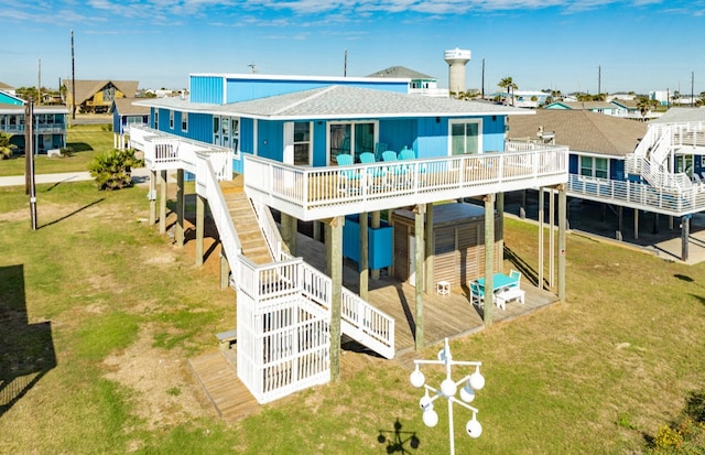 back of house featuring a lawn and a wooden deck