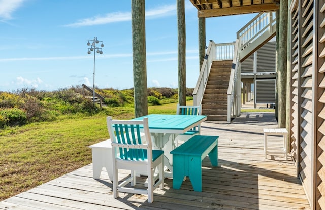 wooden terrace with a lawn