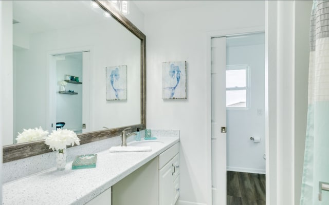 bathroom with vanity and hardwood / wood-style flooring