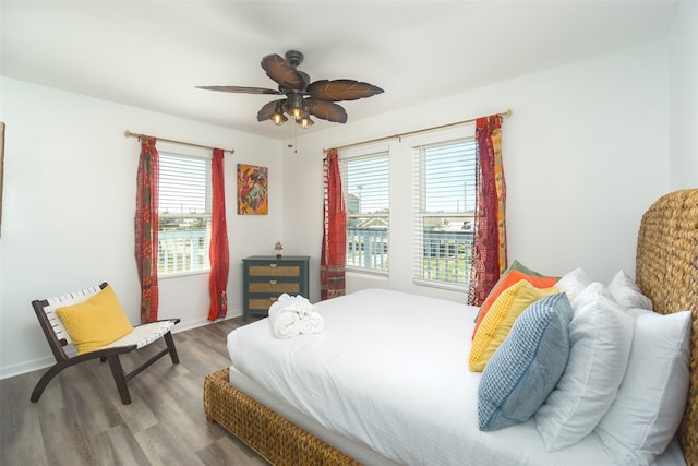 bedroom with ceiling fan and wood-type flooring