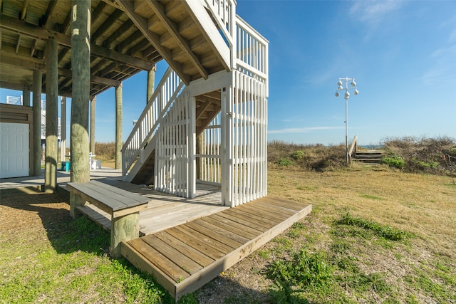 wooden terrace featuring a yard