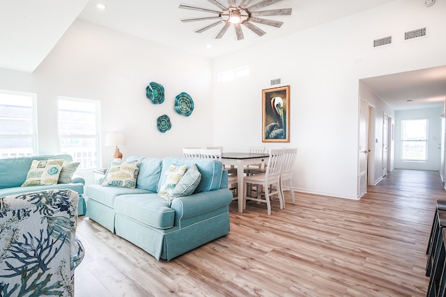 living room with light wood-type flooring and ceiling fan