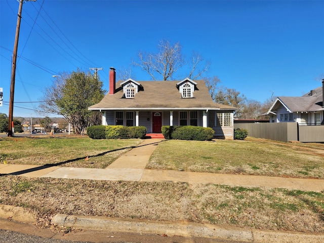 view of front of property with a porch and a front lawn