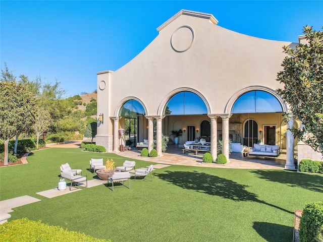 rear view of house featuring a patio area, a lawn, and outdoor lounge area