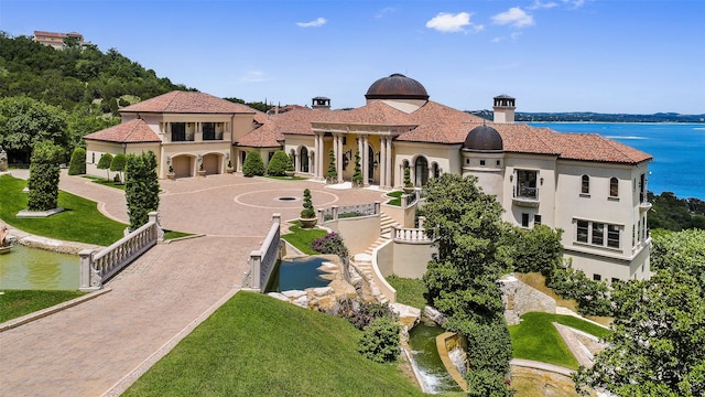 exterior space featuring a lawn and a water view