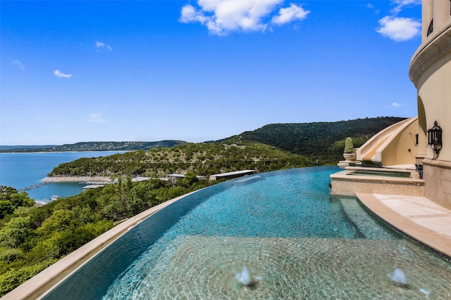 view of pool featuring a water view