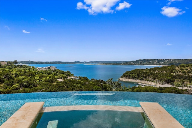 view of swimming pool with a water view