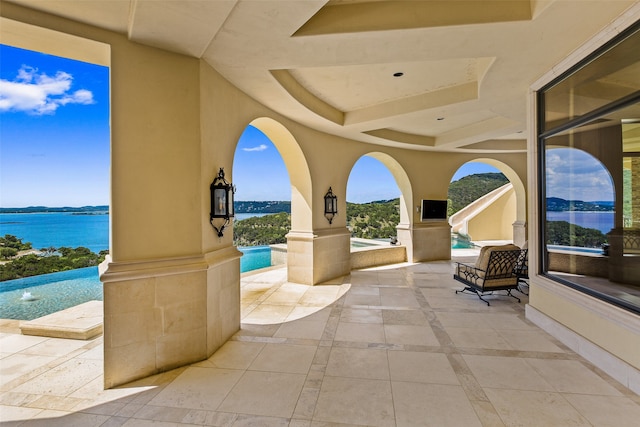 view of terrace with a water view