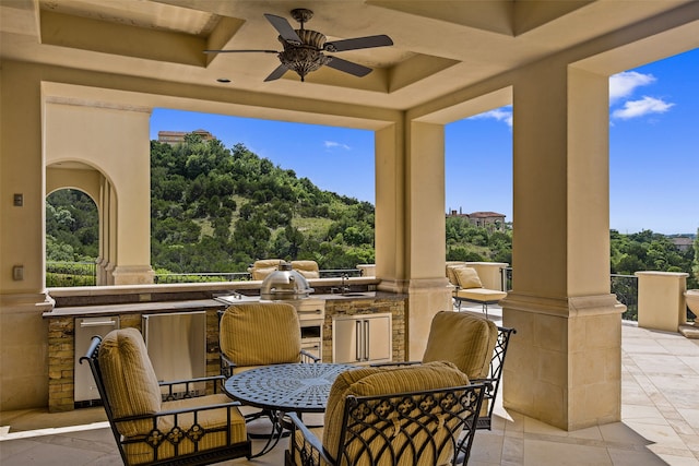 view of patio with exterior kitchen and ceiling fan