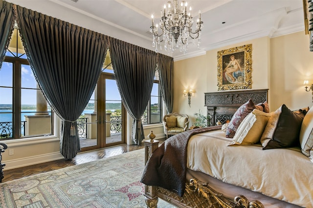 bedroom featuring dark parquet floors, access to exterior, ornamental molding, a chandelier, and a water view