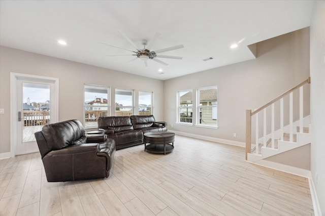 living room featuring ceiling fan and light hardwood / wood-style flooring