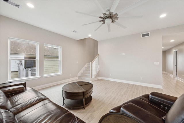 living room featuring ceiling fan and light hardwood / wood-style flooring