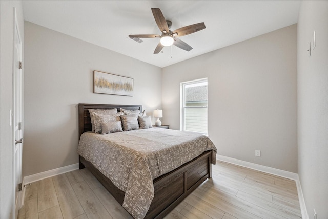 bedroom with light wood-type flooring and ceiling fan