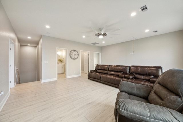 living room with ceiling fan and light wood-type flooring