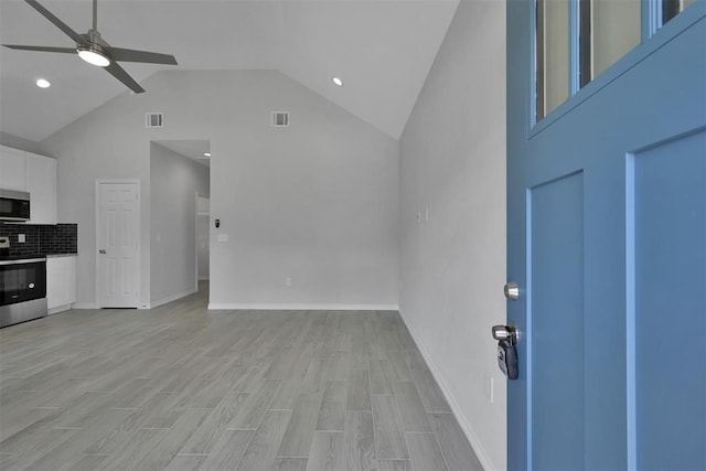 interior space with high vaulted ceiling, ceiling fan, and light hardwood / wood-style flooring