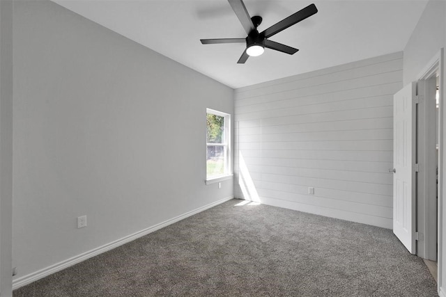 unfurnished bedroom featuring ceiling fan and dark colored carpet