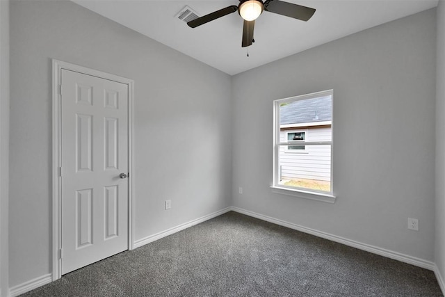 carpeted spare room with ceiling fan