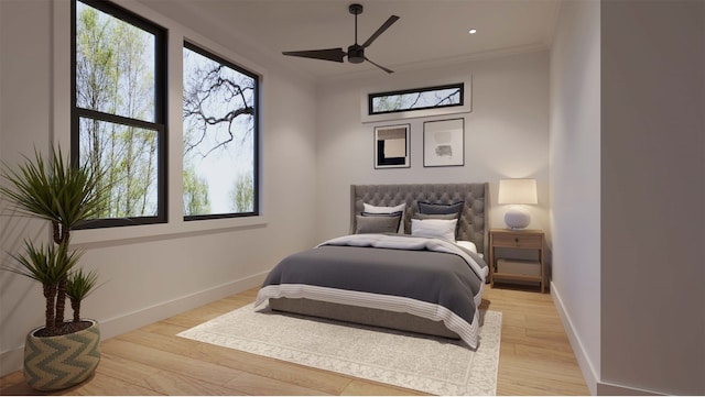 bedroom with light hardwood / wood-style flooring, ceiling fan, and multiple windows