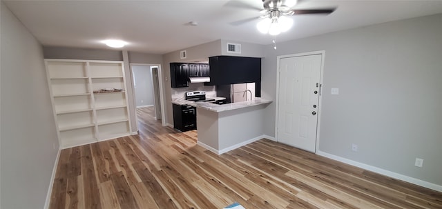 kitchen featuring kitchen peninsula, ceiling fan, wood-type flooring, and stainless steel range with electric stovetop