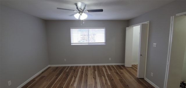 unfurnished bedroom with dark wood finished floors, a ceiling fan, and baseboards