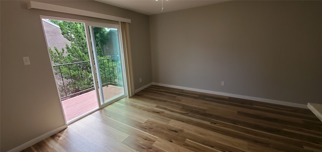 empty room featuring baseboards and wood finished floors