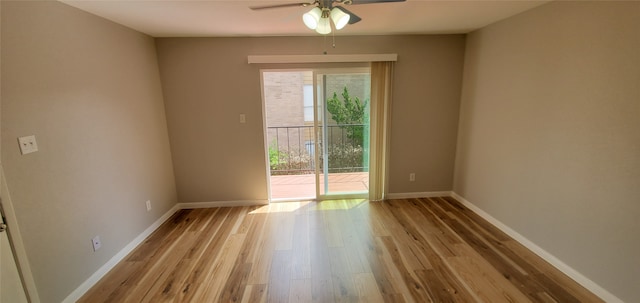 empty room featuring a ceiling fan, light wood finished floors, and baseboards