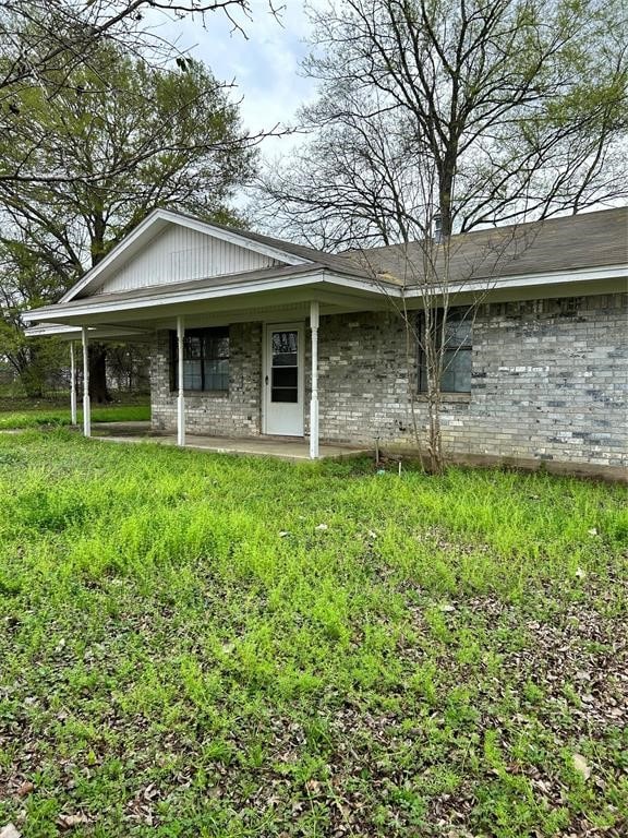 view of side of home with a lawn