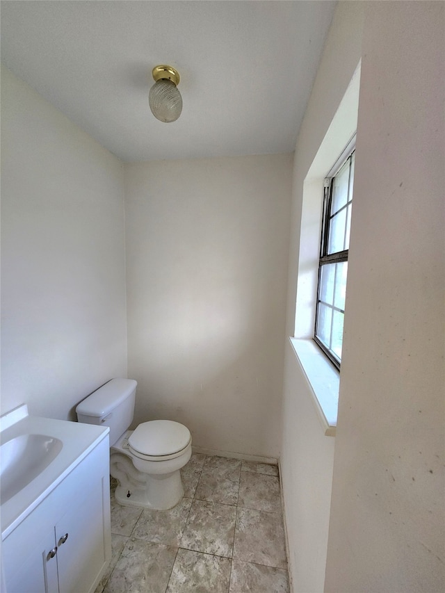 bathroom featuring vanity, tile floors, and toilet