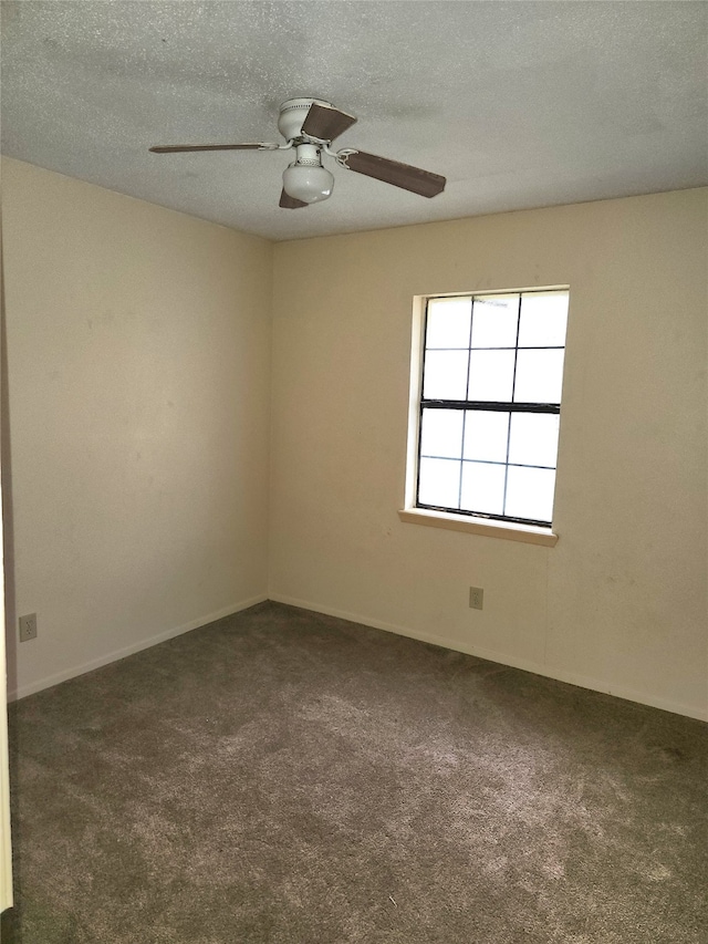 carpeted spare room with a textured ceiling and ceiling fan