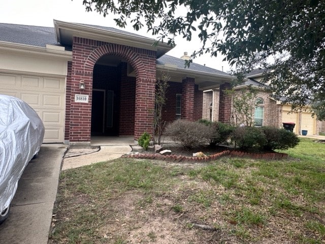 single story home with a front yard and a garage