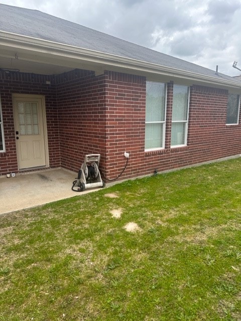 view of side of home with a lawn