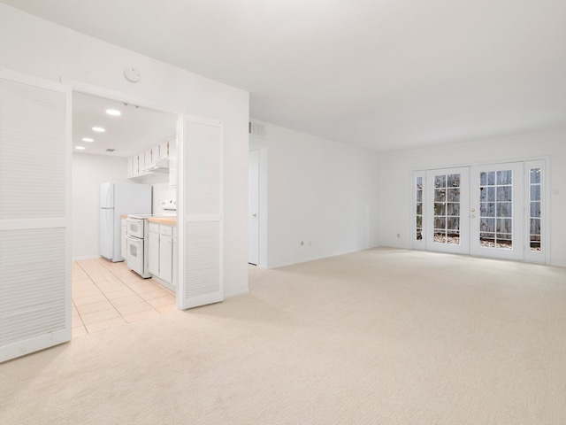 carpeted empty room with french doors